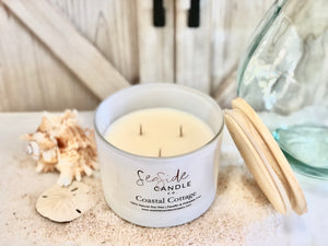 Escape to a tranquil beachside retreat with our Coastal Cottage candle. This elegant fragrance harmoniously blends refreshing bergamot and sea salt top notes with a heart of mint and peony, anchored by base notes of juniper, light musk, and marine accords, creating a soothing and atmospheric scent.