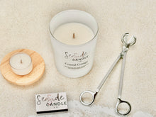 Load image into Gallery viewer, ✨ Introducing Our First Ever Candle Bundle – Coastal Cottage 🌊
Looking for the perfect way to treat yourself or gift someone special?
Our thoughtfully priced Coastal Cottage Bundle is a curated candle experience that brings elegance, fragrance, and function together in one beautiful set.

🕯️ Choose from 3 candle sizes
✂️ Select a black or silver wick trimmer
🔥 Includes a chic matchbook + surprise tealight in a different scent
🌊 Light our Coastal Cottage candle and let its soothing fragrance transport 