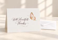 Load image into Gallery viewer, With Heartfelt Thanks greeting card with espresso brown lettering, a delicate butterfly, and a gold flourish, beside a white envelope.